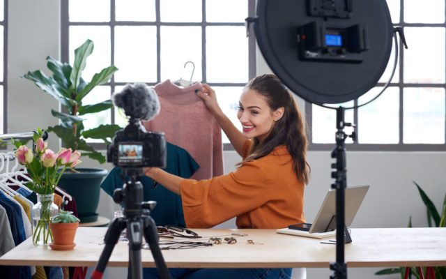 Young female vlogger recording content for her online fashion channel on social media, giving fashion advice